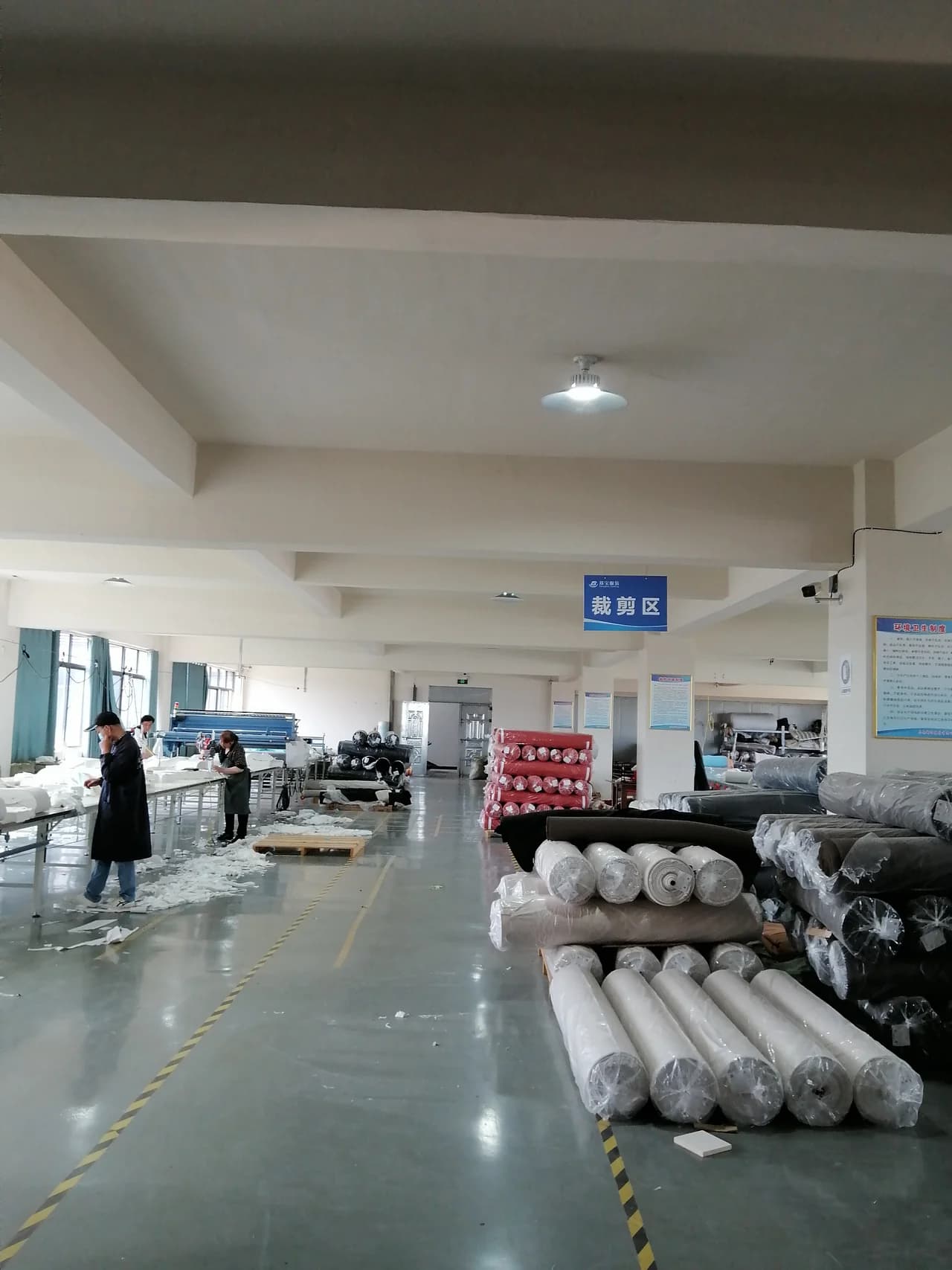 Large cutting floor prepared for bulk fabric handling and marker execution.