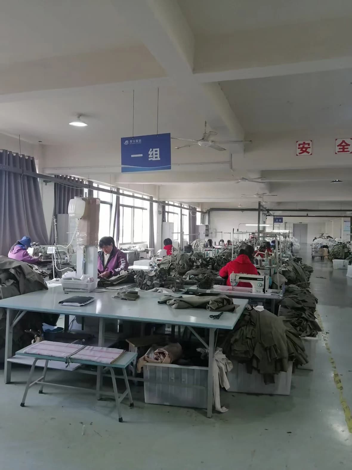 Sewing line with operators assembling garments.