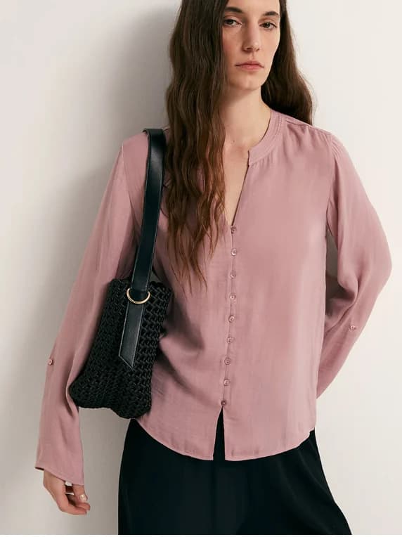 Dusty rose woven blouse styled with relaxed tailoring.